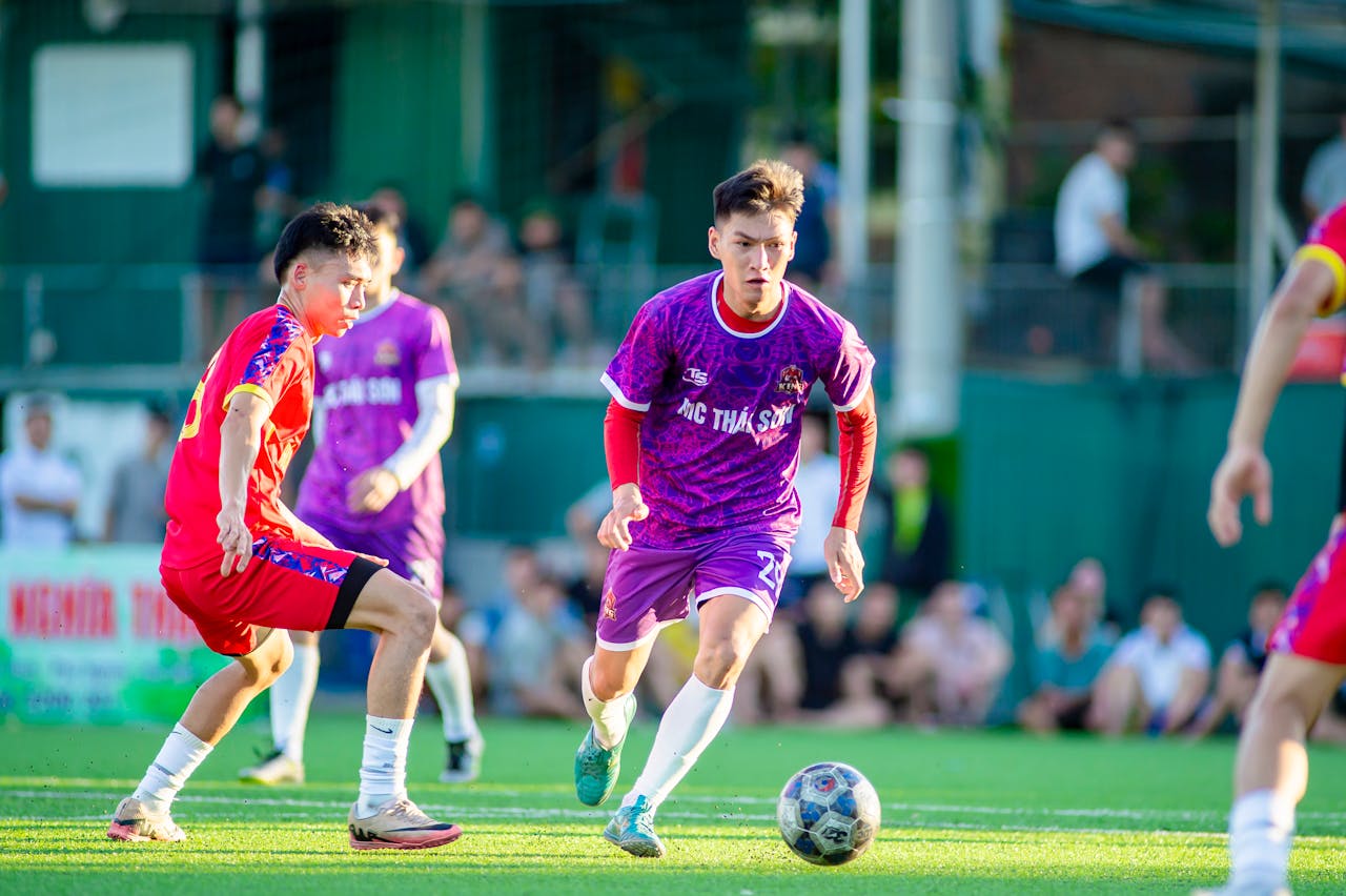 Dynamic action scene of a youth football match in Hà Nội, showcasing competitive spirit and teamwork.